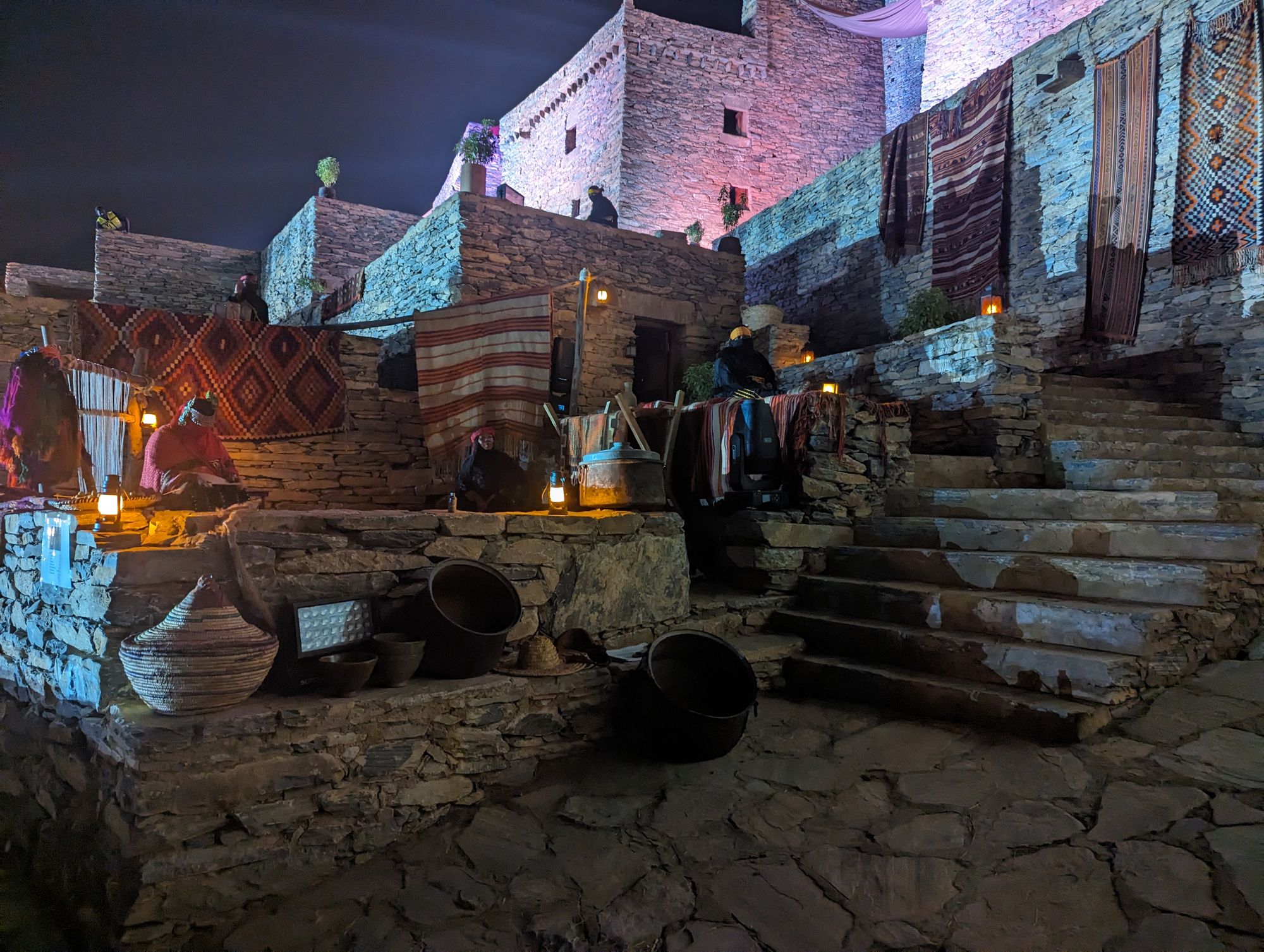 Zee Ain village at night, weavers and lanterns on the stone terraces, A Leap in Time